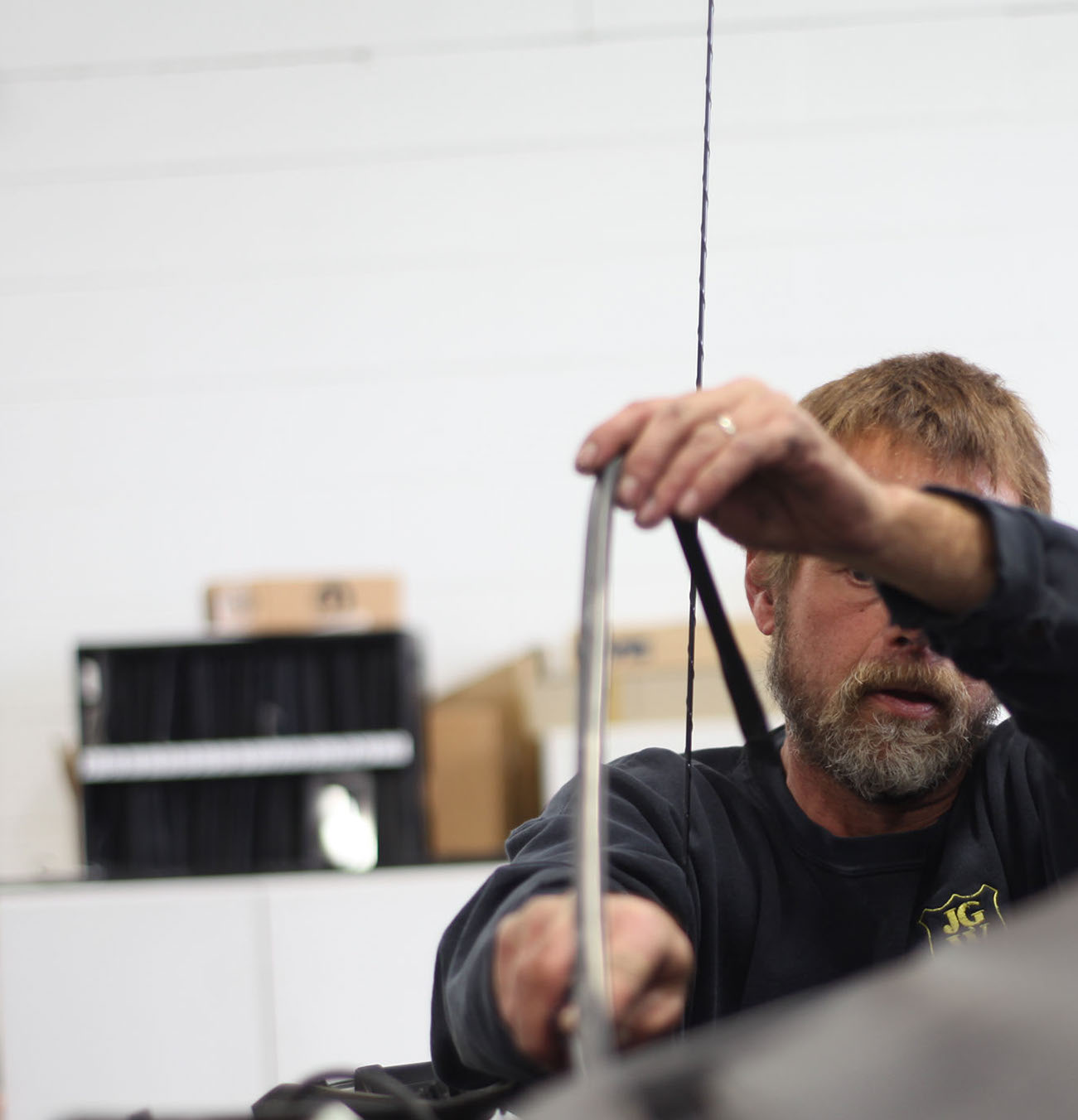 A photograph of a Jackson Glass Works employee replacing a windshield